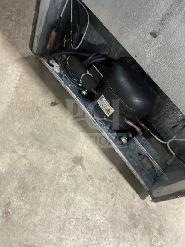 Frigidaire EFRF694 stainless steel upright freezer base interior, showing electric components and wiring in used condition.