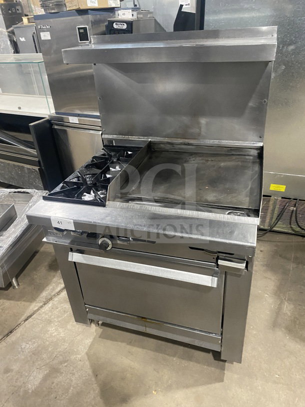 Commercial stainless steel gas range with 2 burners, plancha grill, convection oven, wire rack, and splashback.