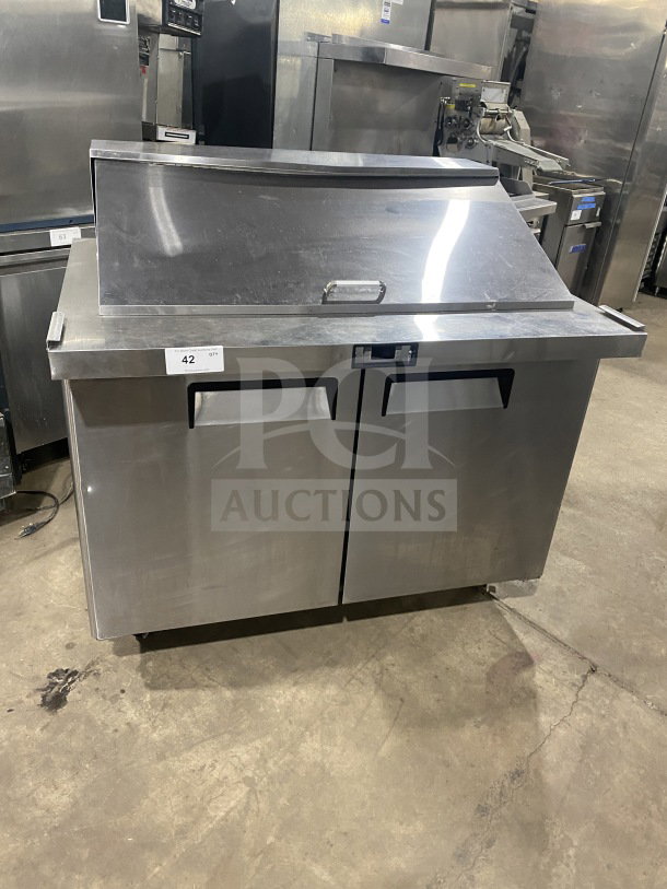 Bison commercial stainless steel refrigerated sandwich prep table, model BST4818, with two-door storage, poly-coated rack, on casters.