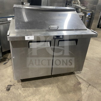 Bison commercial stainless steel refrigerated sandwich prep table, model BST4818, with two-door storage, poly-coated rack, on casters.