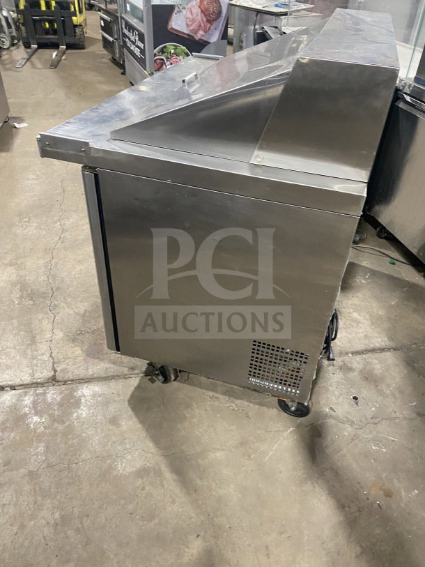 Bison commercial stainless steel refrigerated prep table, model BST4818, with two-door storage, poly-coated rack, on casters.