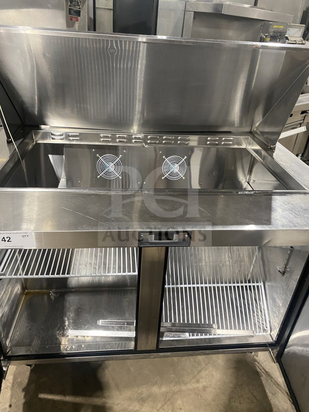 Bison refrigerated sandwich prep table, stainless steel, model BST4818, with two-door storage, poly-coated rack, and casters.