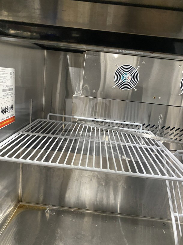 Bison BST4818 stainless steel refrigerated prep table with two-door storage, poly-coated wire rack, on casters, 115V.