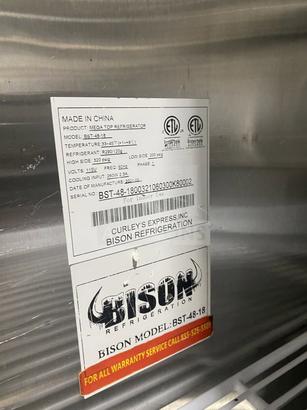 Bison BST4818 stainless steel mega top sandwich prep table, with 2-door storage, poly-coated rack, and caster wheels. 115V, 1 phase.
