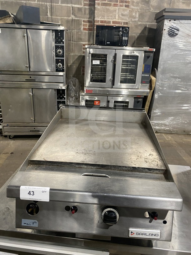 Garland G1GG24-G24 stainless steel gas griddle with back and side splash, countertop model, on legs, used condition.