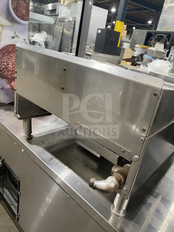 Garland stainless steel flat griddle, model G1GG24-G24, natural gas, with back and side splash, on legs, SN: 2206100101348.