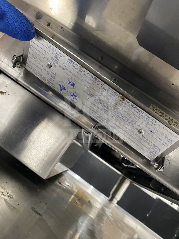 Garland stainless steel heavy-duty countertop griddle, model G1GG24-G24, with back and side splash, on legs. Serial number visible.