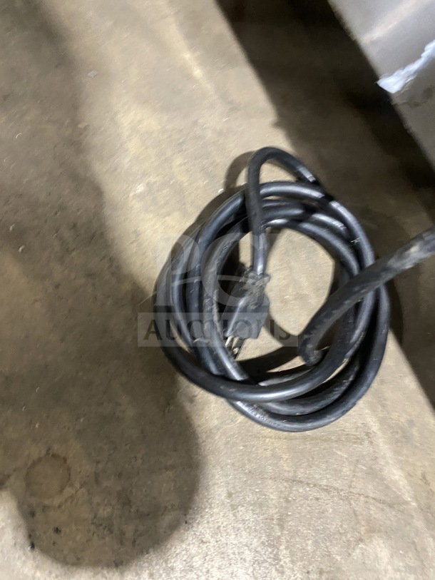 Power cord for Cooltech CUST48CF chef base refrigerator, 120V. Heavy duty; shown coiled on a concrete floor.
