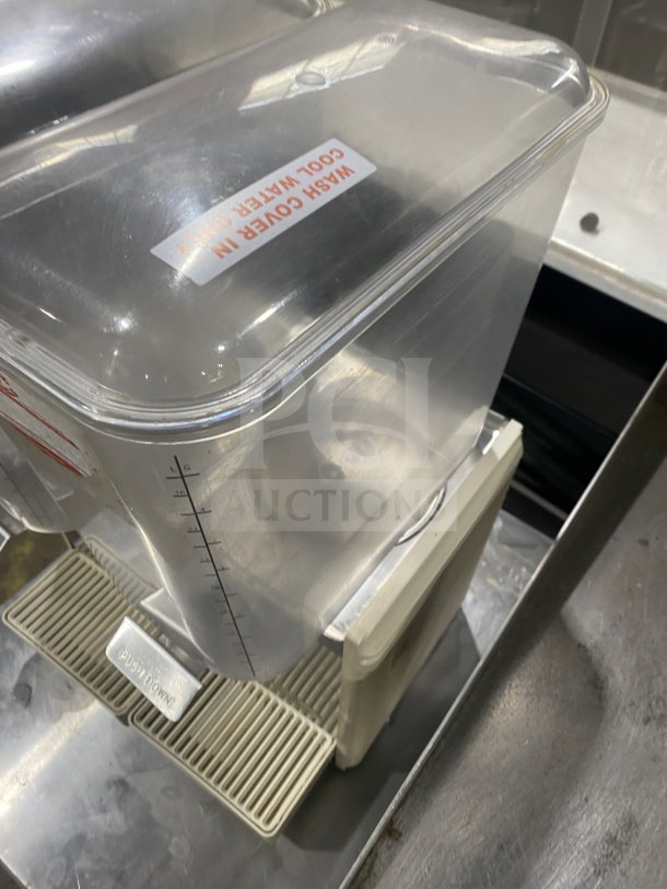 Crathco D25-4 beverage dispenser with clear hoppers and double drip trays. Stainless steel, electric, countertop model. 115V.