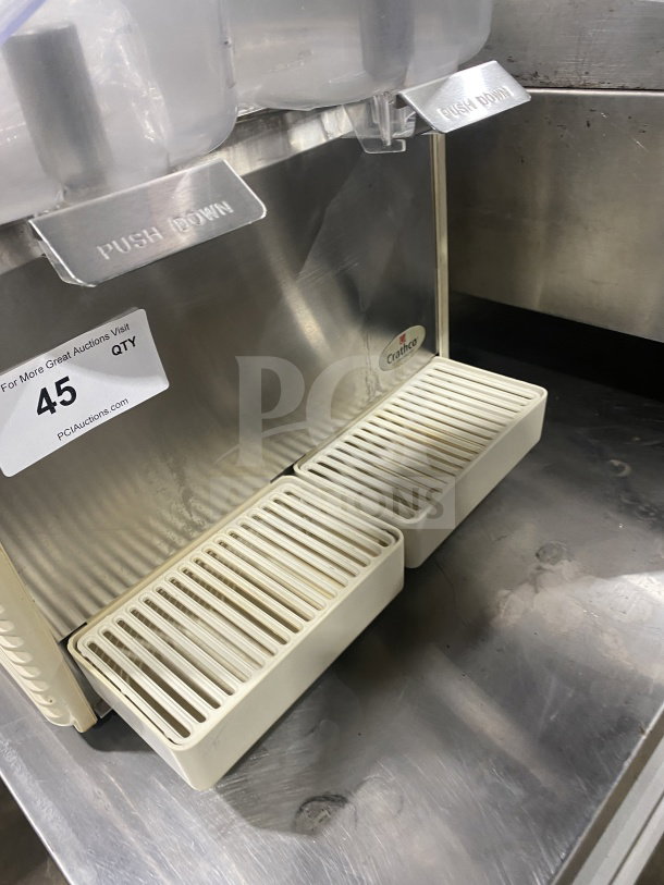 Crathco D25-4 twin beverage dispenser with clear hoppers, stainless steel body, and double drip trays. Model: D25-4, 115V.