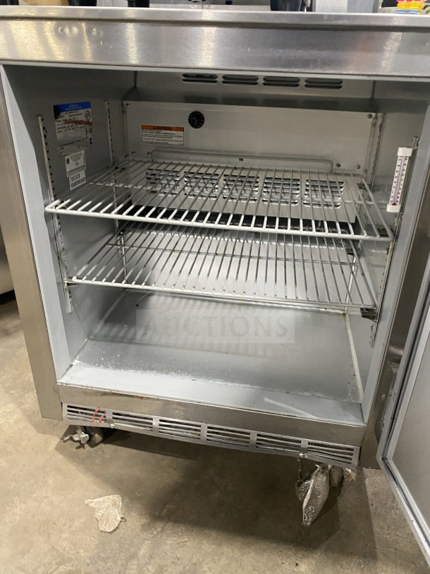 Beverage-Air UCR27Y stainless steel undercounter refrigerator, single door, poly coated rack, on casters, model tag visible.