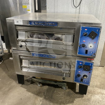 Bakers Pride stainless steel double deck pizza oven on casters and legs. Electric powered, visible control panel, commercial use.