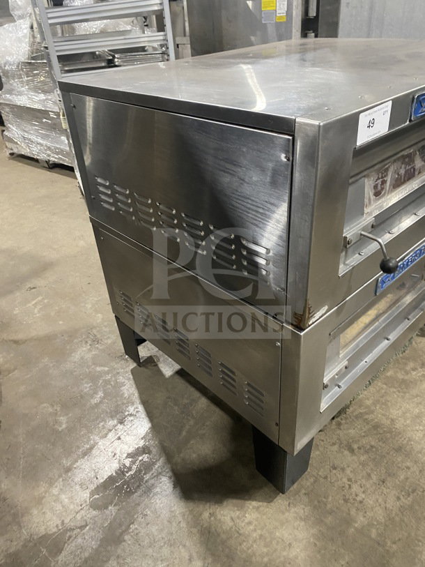 Bakers Pride commercial stainless steel double deck pizza oven on casters, electric powered, visible vents, on legs, good condition.