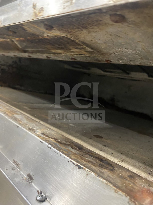Bakers Pride stainless steel double deck pizza oven; electric powered; visible wear; on casters; auction piece.