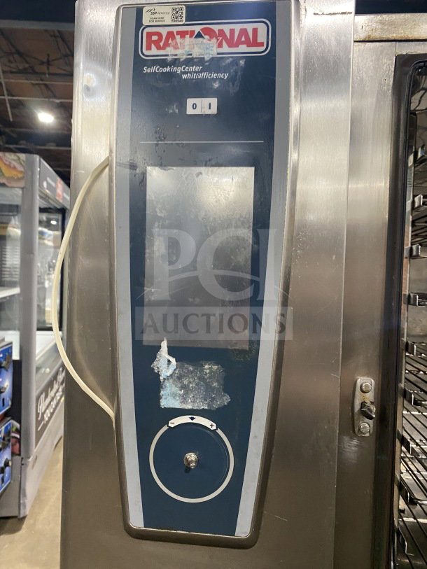 Rational White Efficiency Series Combi Convection Oven with wired rack, pan-holding stand, visible wear on control panel.