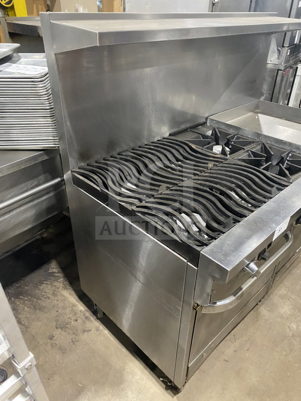 Southbend commercial stainless steel 6-burner range with 24" flat griddle and 2 full-size ovens on casters; includes poly wired oven rack.