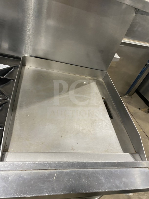 Southbend commercial stainless steel range with 6 burners, 24" griddle, and 2 full-size ovens. On casters, poly wired oven rack.
