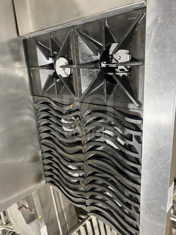 Southbend commercial stainless steel range with 6 burners, 24" griddle, 2 ovens, wire rack, on casters. Good condition.