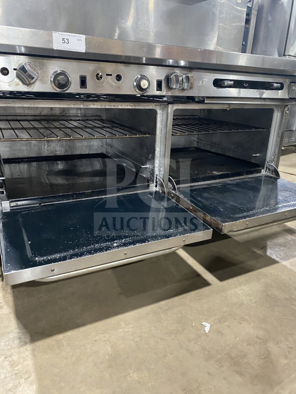 Southbend commercial stainless steel 6-burner range with 24" flat griddle, two ovens, poly wired rack, on casters.