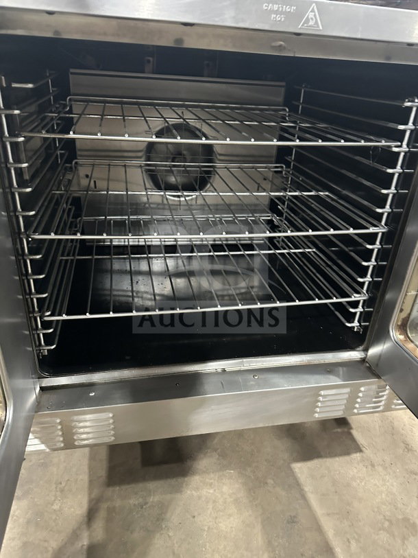 US Range commercial stainless steel gas convection oven with simple controls and wired oven rack, in good condition.