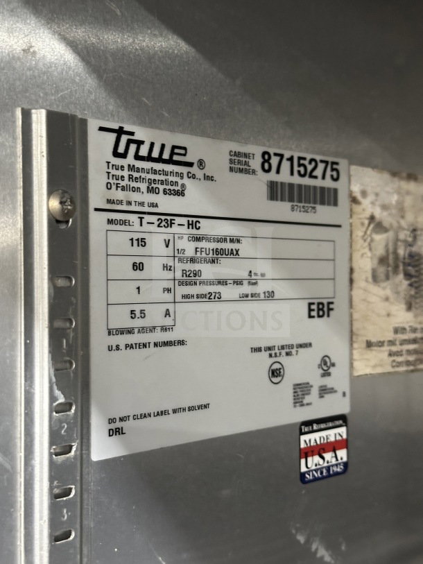 True T23FHC single door freezer, stainless steel, electric, 115V, model details tag shown; on casters; poly-coated rack.
