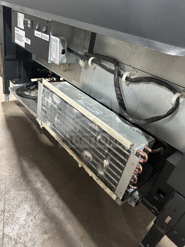 Structural Concepts SB25452DR commercial refrigerated merchandiser with sliding rear doors, exposed cooling system, good condition.