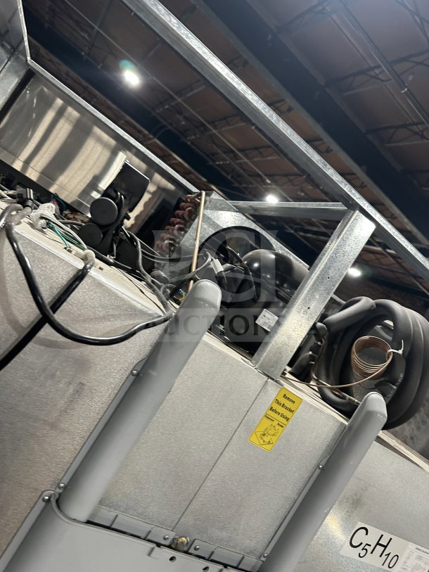 Migali T-Series C-27 stainless steel 2-door freezer, 115V, 1 phase, on casters. Visible wiring and warning label.