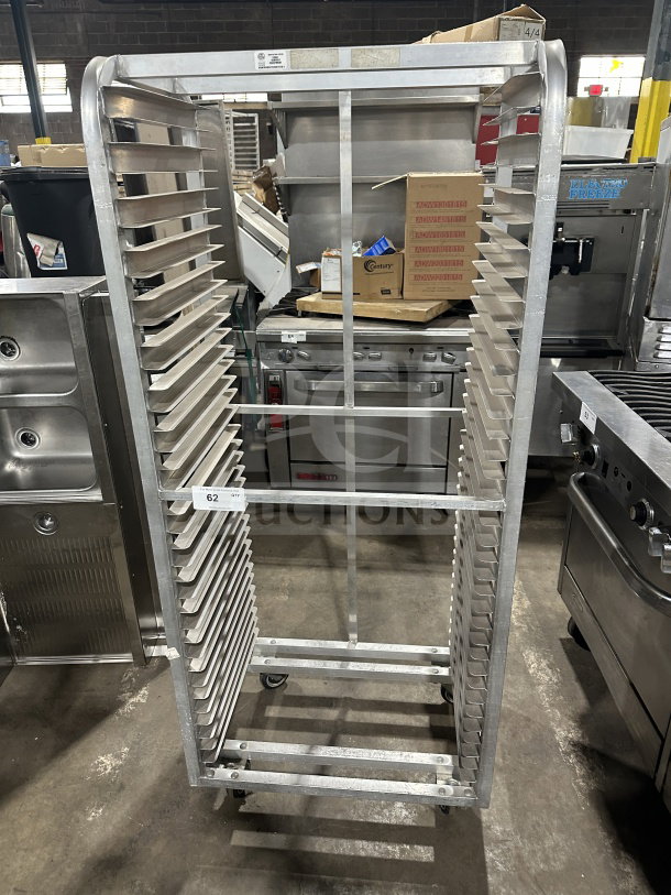 Commercial stainless steel heavy-duty sheet pan rack on casters, used, with 20 slots, durable construction, item tag 62.