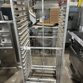 Commercial stainless steel heavy-duty sheet pan rack on casters, used, with 20 slots, durable construction, item tag 62.
