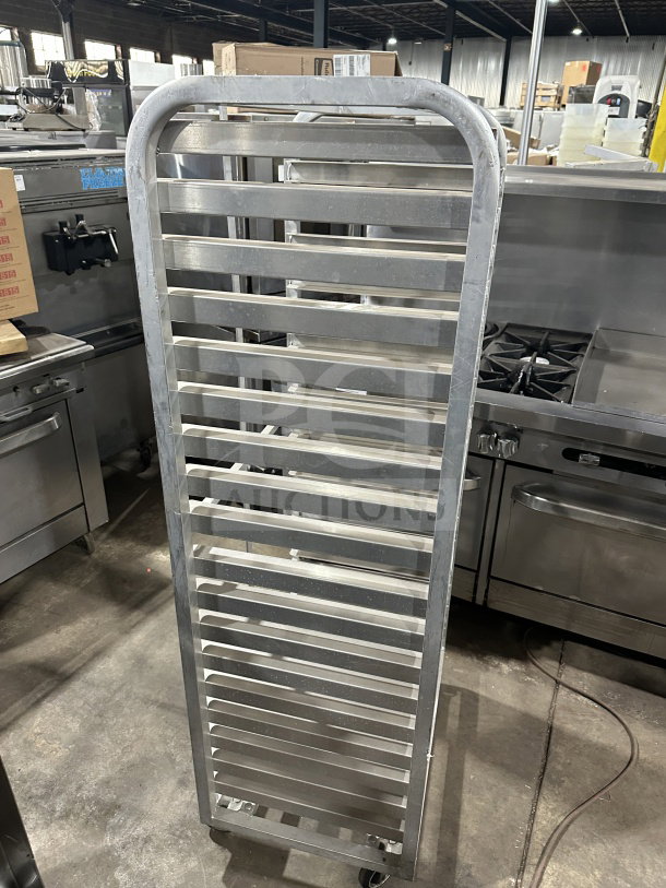 Commercial stainless steel heavy-duty sheet pan rack on casters, vertical slats, durable, excellent condition.