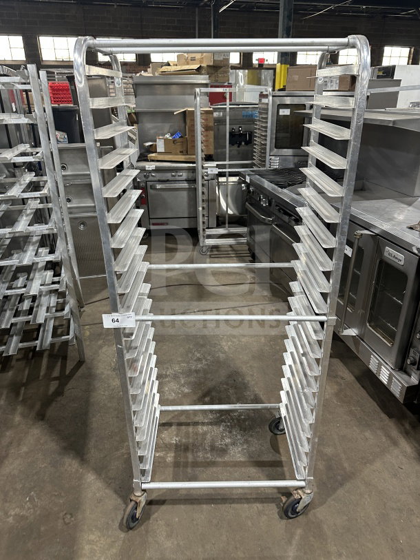 Regency stainless steel heavy-duty bun pan rack, 20-slot, commercial use, excellent condition, caster wheels, item 64 visible.