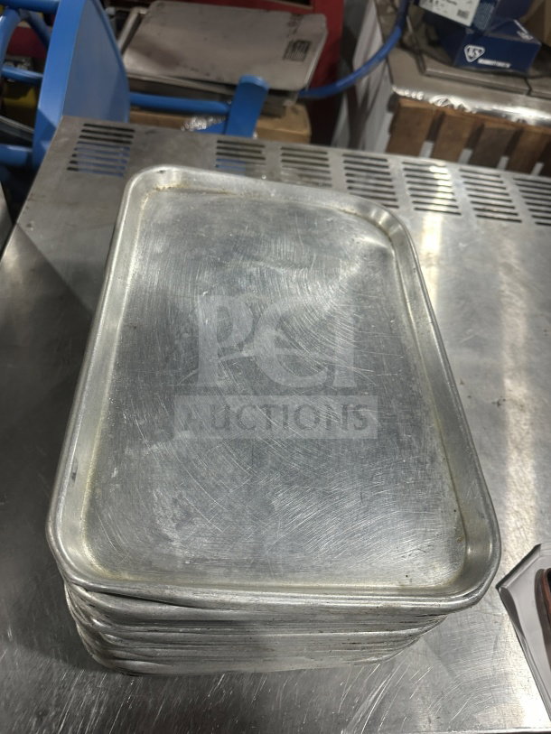 Commercial heavy-duty stainless steel display trays, stack of 27, used condition, 27"x your bid, durable design.