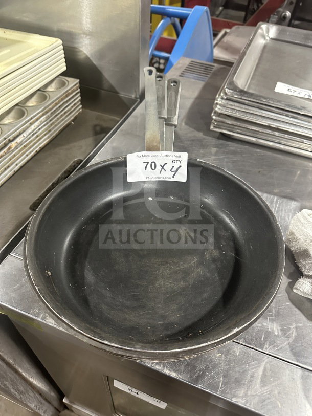 Commercial heavy-duty aluminum non-stick fry pan in used condition. Note: Auction lot includes quantity of four.