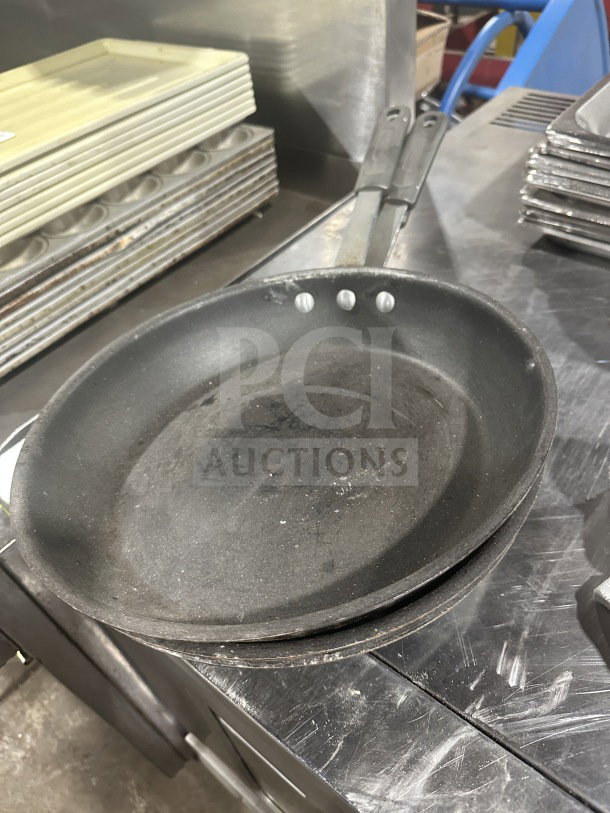 Commercial heavy-duty aluminum non-stick frypan, slightly used, durable construction, dual riveted handle, ideal for professional kitchens.