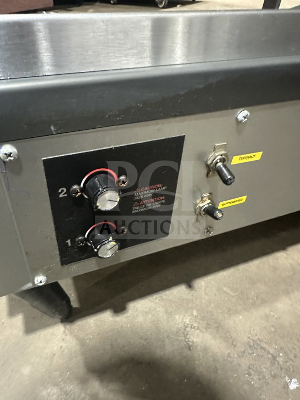 Hatco 30" stainless steel electric slanted double shelf merchandiser display warmer, model GRSDS30D, with control knobs and switches visible.