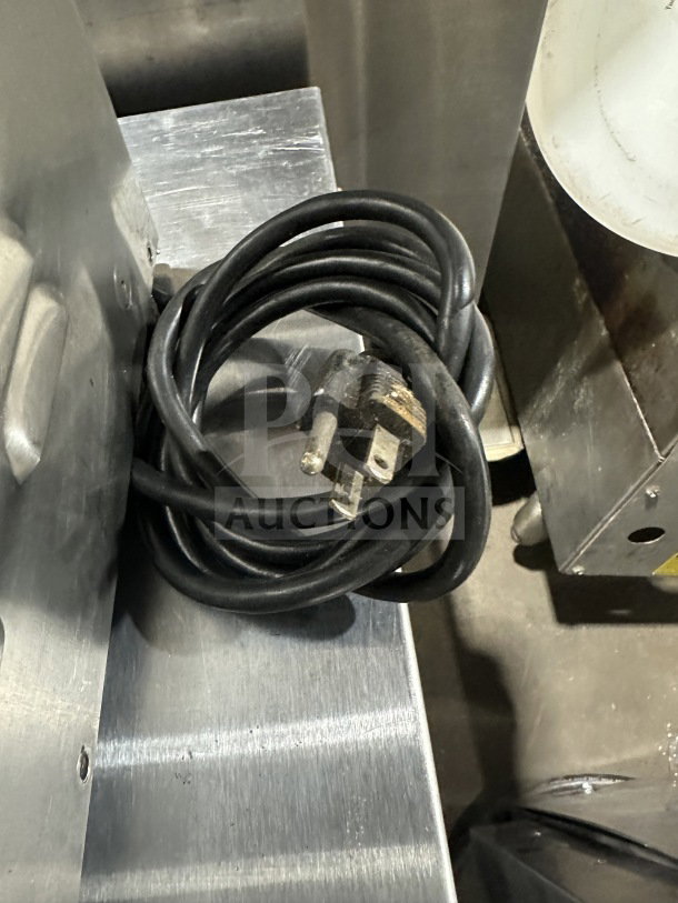 Prince Castle Model 413 stainless steel electric corn carousel, 115V, with coiled power cord. Visible wear, used condition.