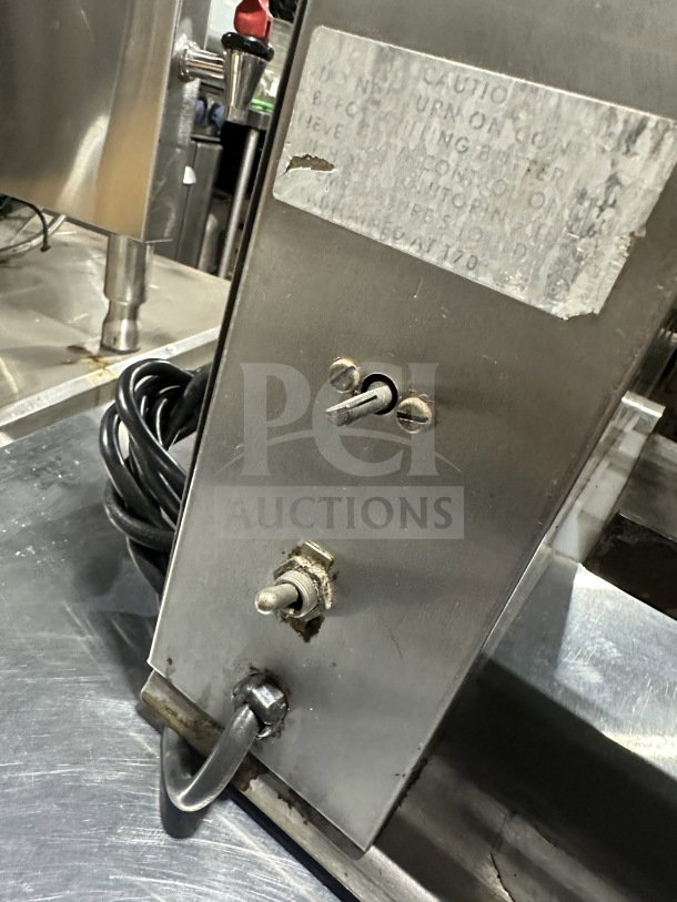 Prince Castle Model 413 electric corn carousel, stainless steel, with visible wear, toggle switch, and caution label. Serial No. 102.