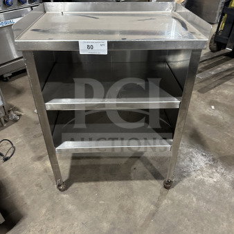 Commercial stainless steel double undershelf equipment stand on casters, used condition, features flat top and undershelves.