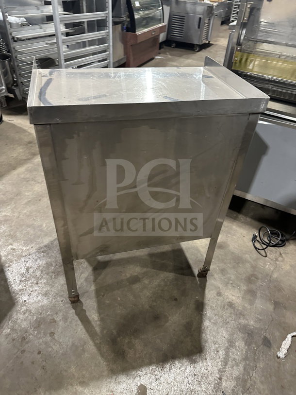 Commercial stainless steel double undershelf equipment stand/cart with casters, in used condition.
