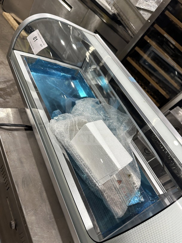 Marchia MSU140S 46" curved glass refrigerated sushi display, new condition, LED lights, double sliding doors, on legs.