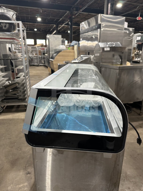 Marchia MSU140S stainless steel 46" refrigerated sushi display with curved glass, LED lights, and double sliding doors. New condition.