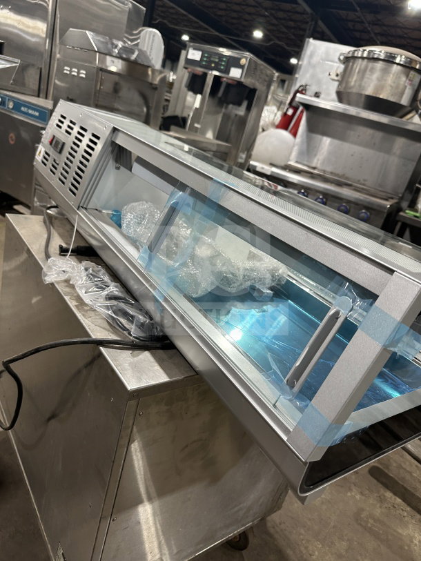 Marchia MSU140S 46" refrigerated sushi merchandiser, stainless steel, curved glass, LED lights, double sliding doors, new condition.
