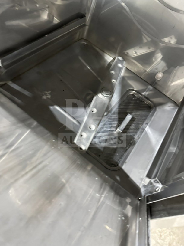 Champion UH130BM4 undercounter dishwasher interior, stainless steel, well-maintained, electric, high-temp wash.