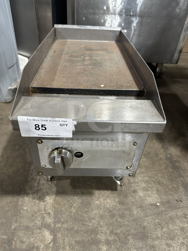 Commercial stainless steel gas-powered countertop flat top griddle on legs. Features a control knob. Used condition.