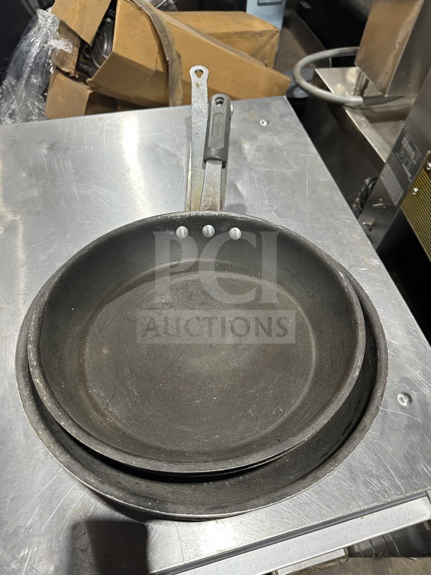 Commercial stainless steel non-stick fry/griddle pan, used condition, visible handle markings, ideal for high-volume cooking.