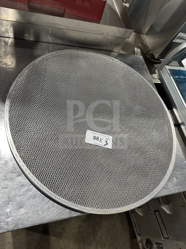 Round aluminum pizza baking screen, commercial-grade, mesh design, slight wear. Sticker: "88, Qty 3."