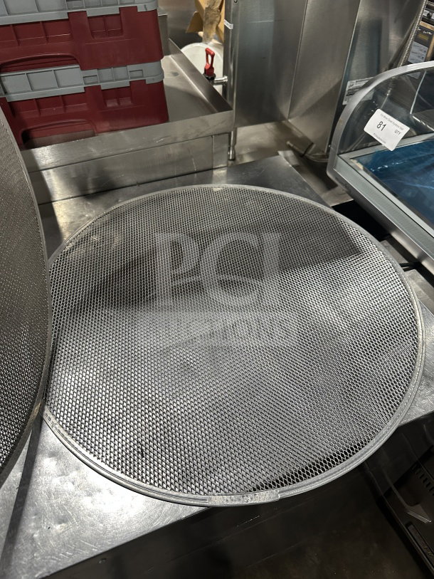Round aluminum pizza baking screen in good condition, mesh design for even baking, auction lot marked "81".