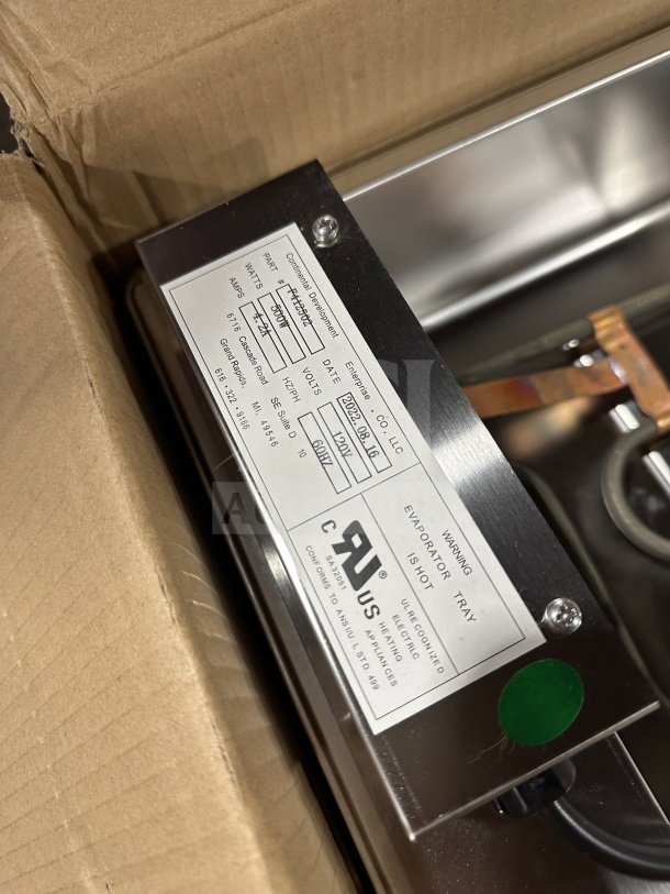 Continental Refrigeration stainless steel evaporator pan, Model F412502, new in box. Features 120V, detailed labeling.