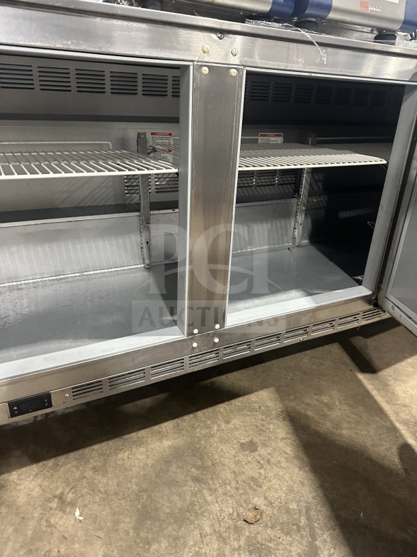 Beverage-Air UCR72AHC commercial stainless steel 3-door undercounter fridge with poly coated racks, 72" wide, on casters.