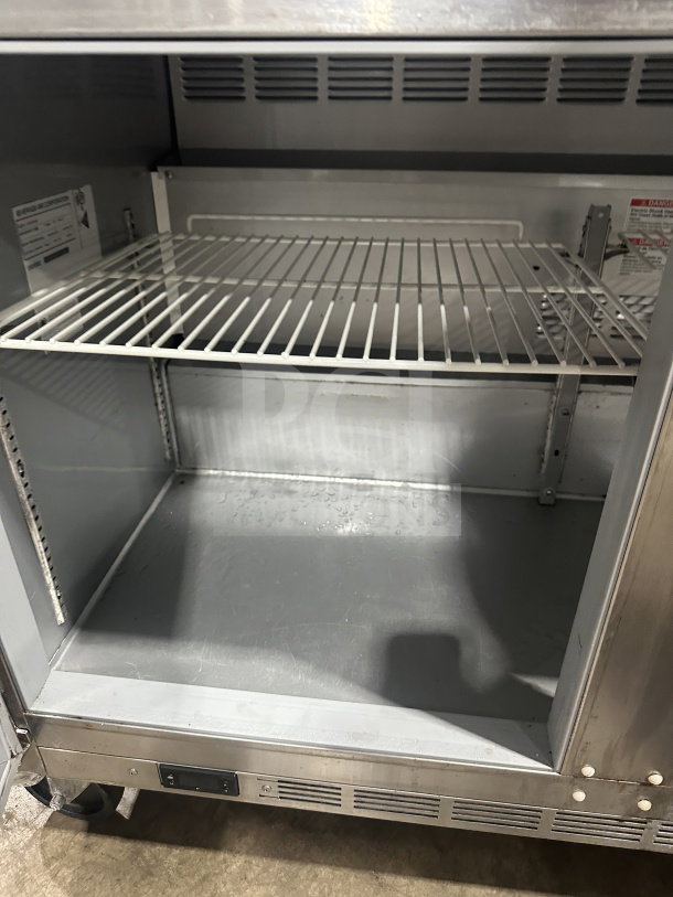 Beverage-Air UCR72AHC stainless steel 3-door undercounter fridge, poly-coated rack, on casters, model label visible.